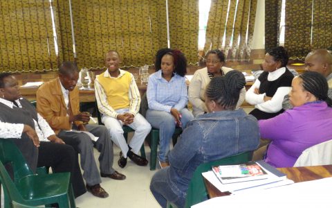Group discussion between parents discussing the best way to resolve a disciplinary issue